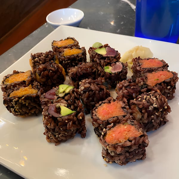Asiana Cafe's black rice sushi rolls with various fillings, including salmon, avocado, and sweet potato.
